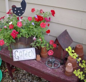 A garden bench holds some recycled treasures