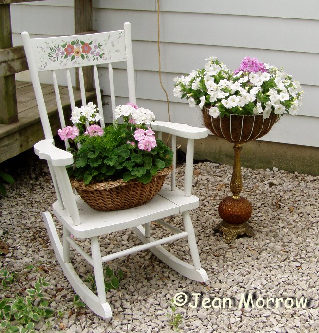 Jean Butcher Morrow Jean Morrow's hand painted chair with baskets of pastel geranium and impatien