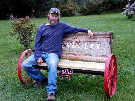 Here is my friend, Larry,  maker of this wagon wheel tailgate bench...